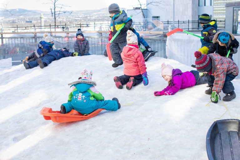 Enfants qui glissent sur une butte de neige